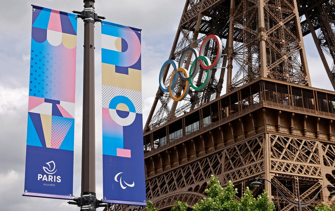 The Paris 2024 logo is displayed near the Eiffel Tower before the start of the Paris 2024 Olympic and Paralympic Games on June 17, 2024 in Paris, France. The city is gearing up to host the XXXIII Olympic Summer Games, from 26 July to 11 August.